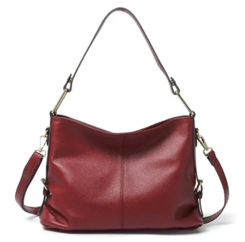 Genuine leather vertical square crossbody bag in black colour with visible stitching and multiple compartments.
