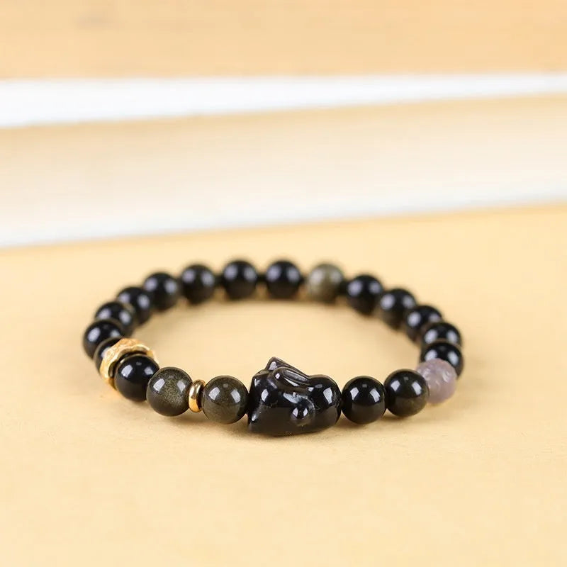 Handmade lying rabbit obsidian bracelet with Jin Yaoshi and brass beads, available in 8mm and 10mm sizes.