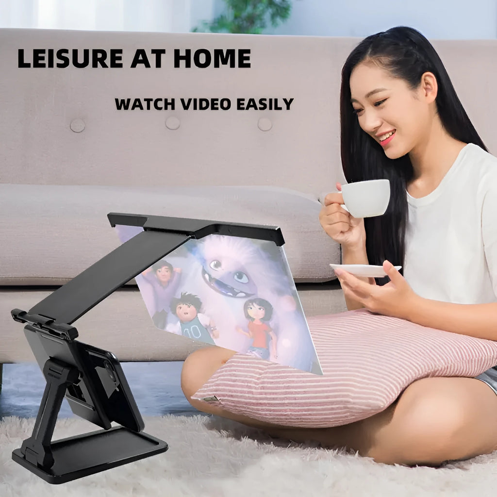 Black folding mobile phone screen amplifier with detachable holder next to an iPhone.