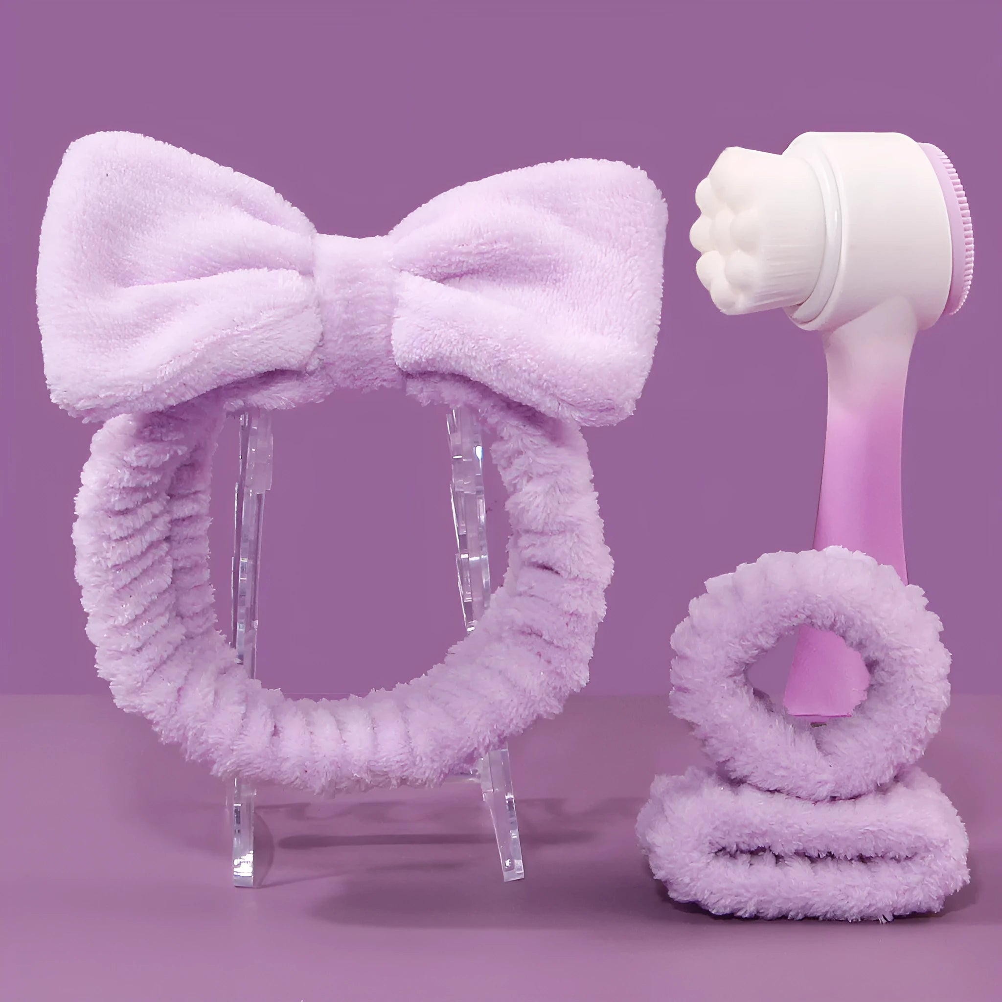 Facial brush set with coral fleece hair band and four nylon brush heads in purple grey white pink colours