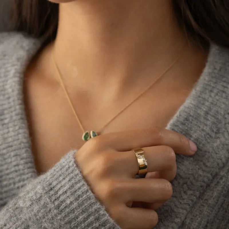 Gold coloured women's ring with a shining zircon stone on a copper band.