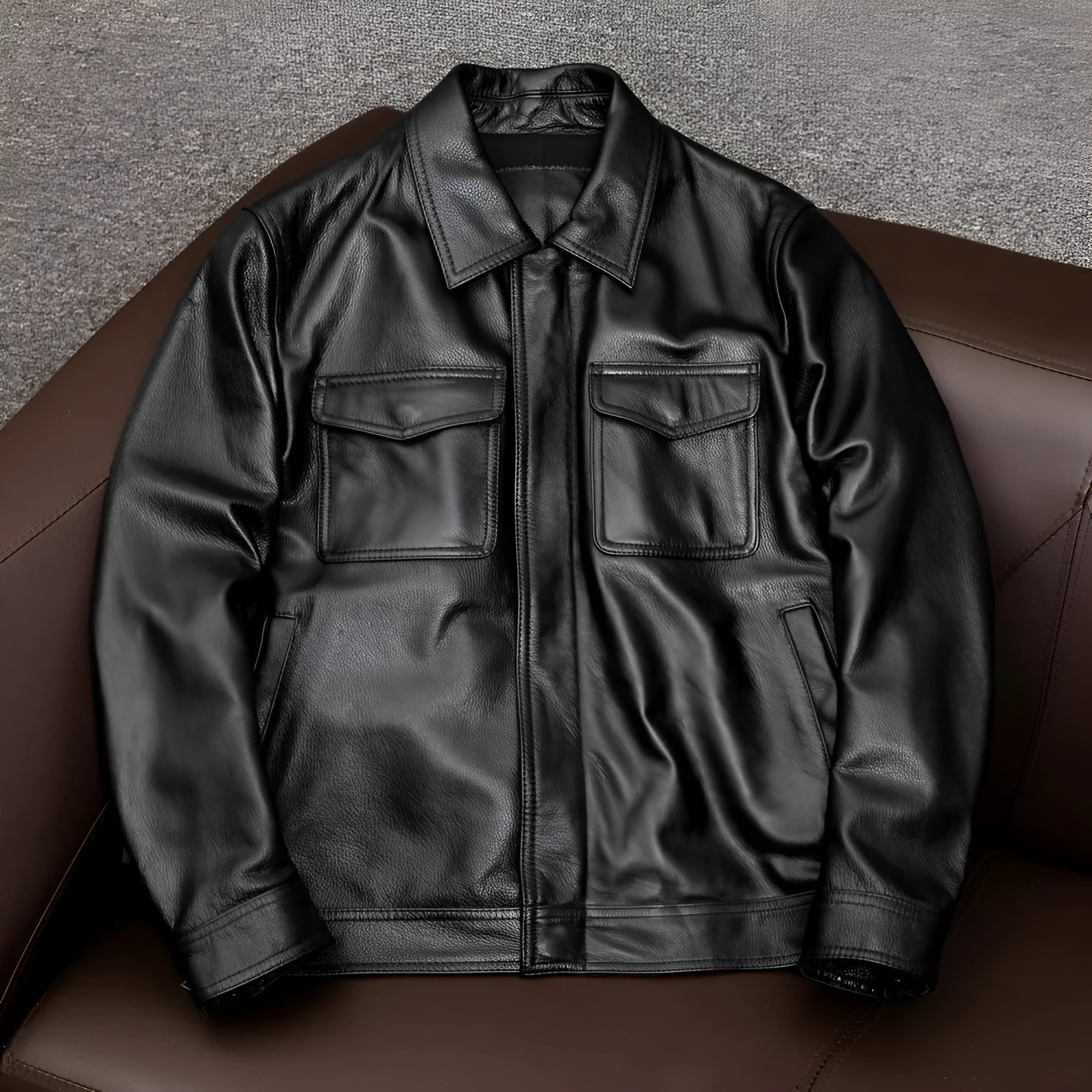 Men's black plus size loose fit PU leather jacket with lapel collar and side pockets.