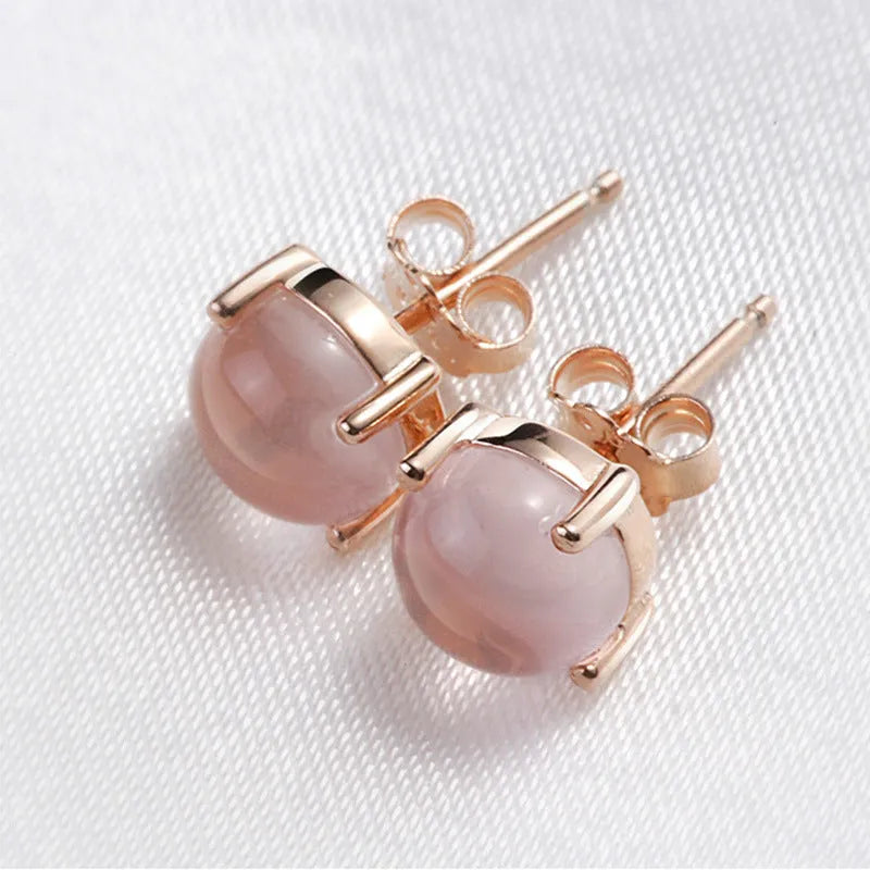 Rose gold plated drop shape stud earrings with a synthetic quartz crystal inlay detail.