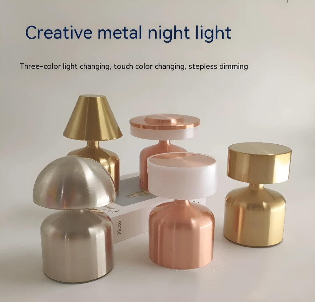 Mini retro dumbbell-shaped LED table lamp in metallic copper finish on a wooden desk