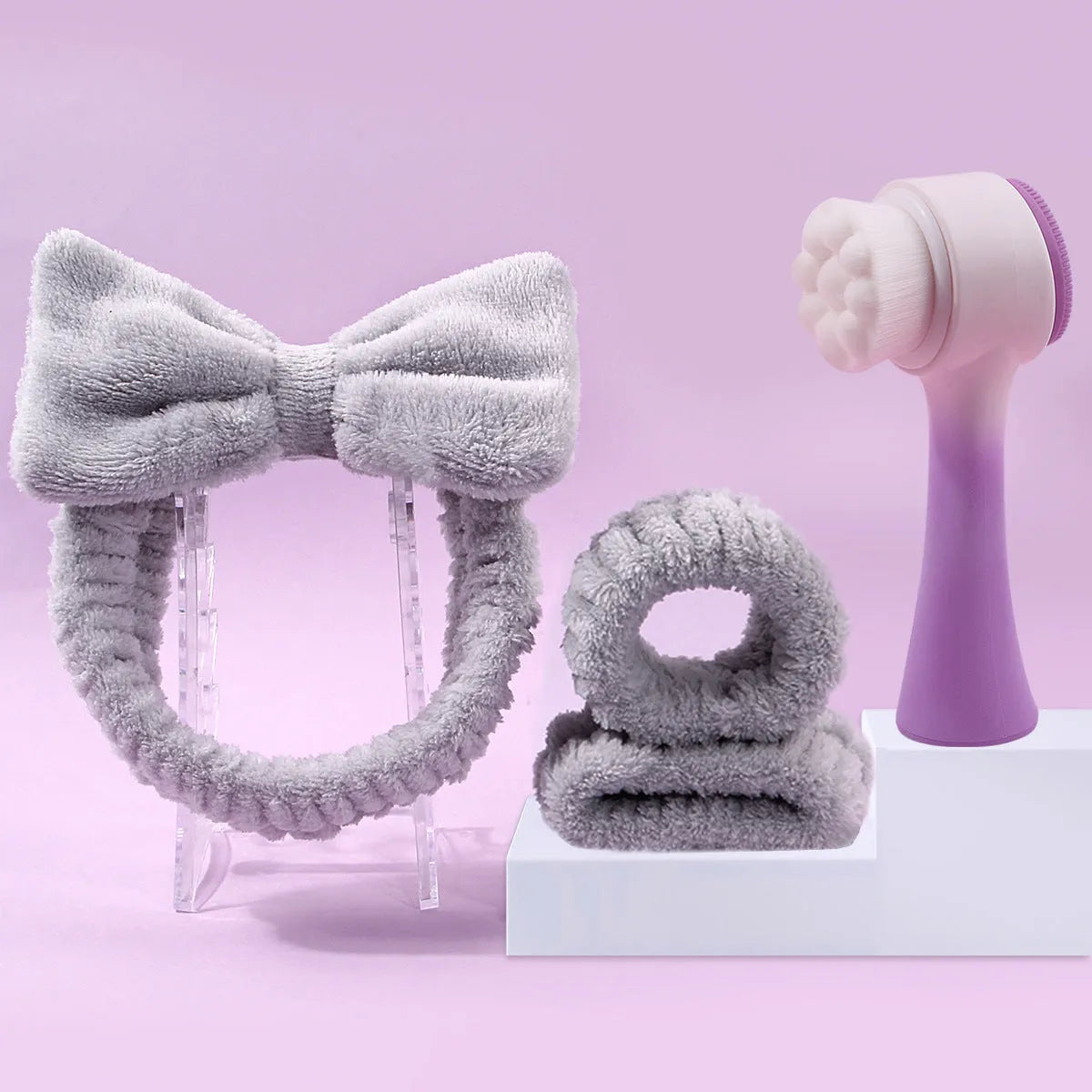 Facial brush set with coral fleece hair band and four nylon brush heads in purple grey white pink colours