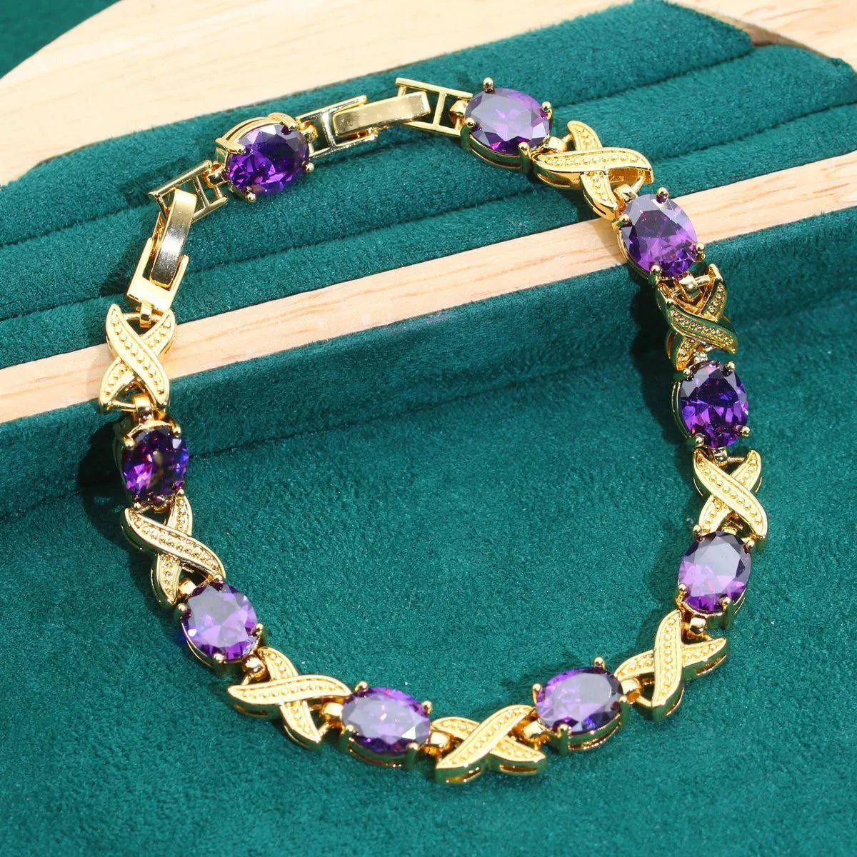18k gold plated jewellery set with multi-colour zircon stones including necklace, earrings, bracelet, and ring on a display.