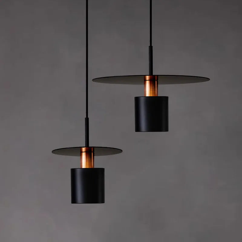 Modern minimalist black droplight pendant 20cm diameter on ceiling over a bedside table
