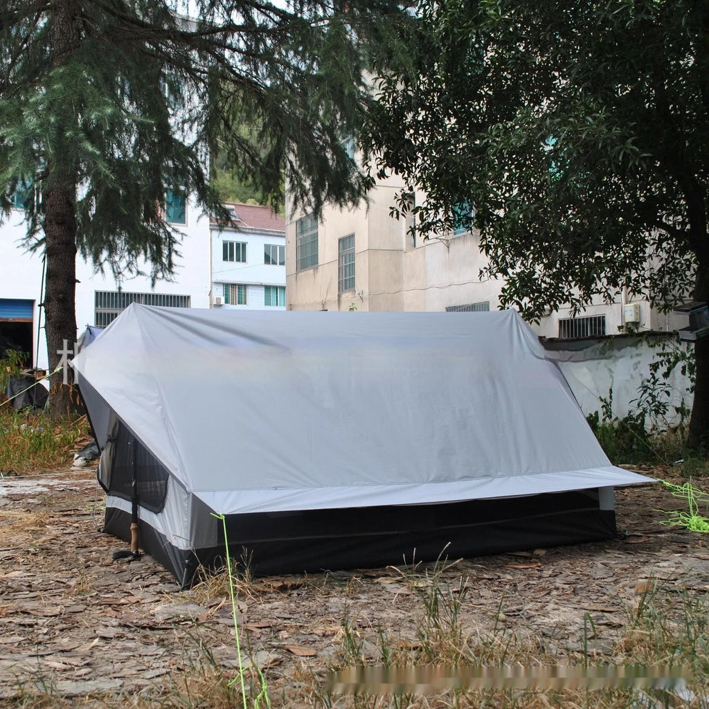 Brown A-line tent pitched with hiking poles, showing guy lines and aluminium ground nails.