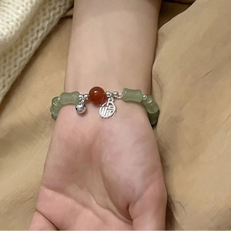 Chinese style glass bead bracelet with bamboo leaf design and manual craftsmanship details.