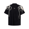 Black women's short-sleeved T-shirt with padded shoulders and rivet ribbon detail.