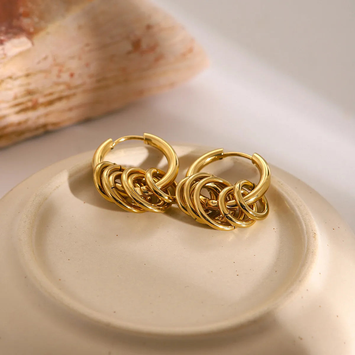 A pair of stainless steel ins style earrings with an electroplated colour finish.