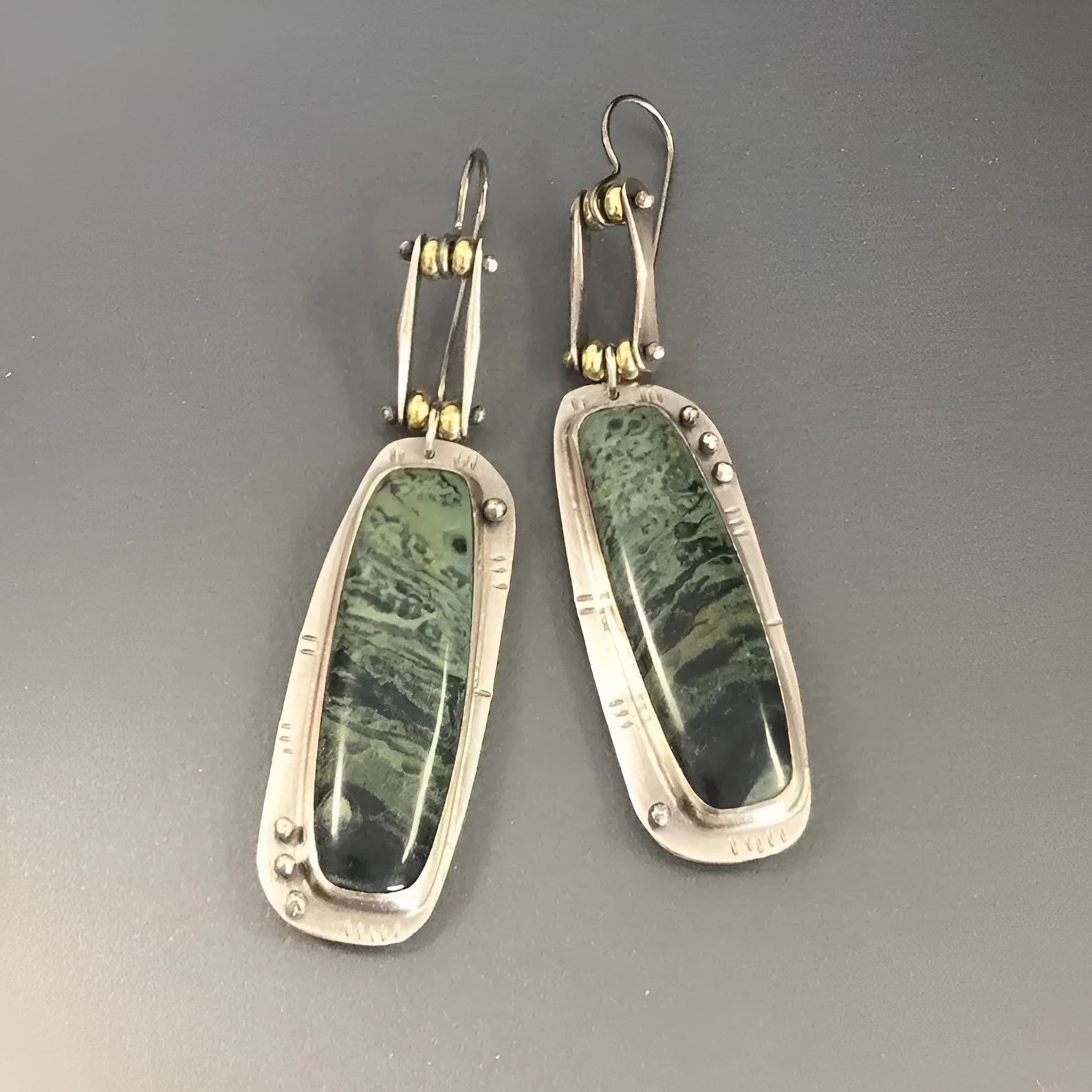 A pair of geometric-shaped fashion earrings with a two-colour marble pattern, made from alloy metal.