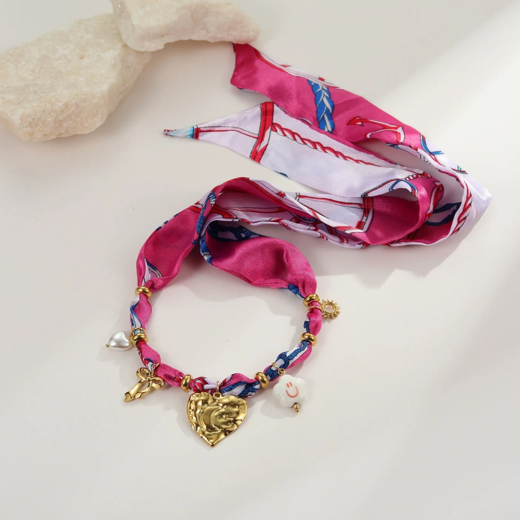 Stainless steel necklace and bracelet set with geometric pendant and gold electroplated finish.
