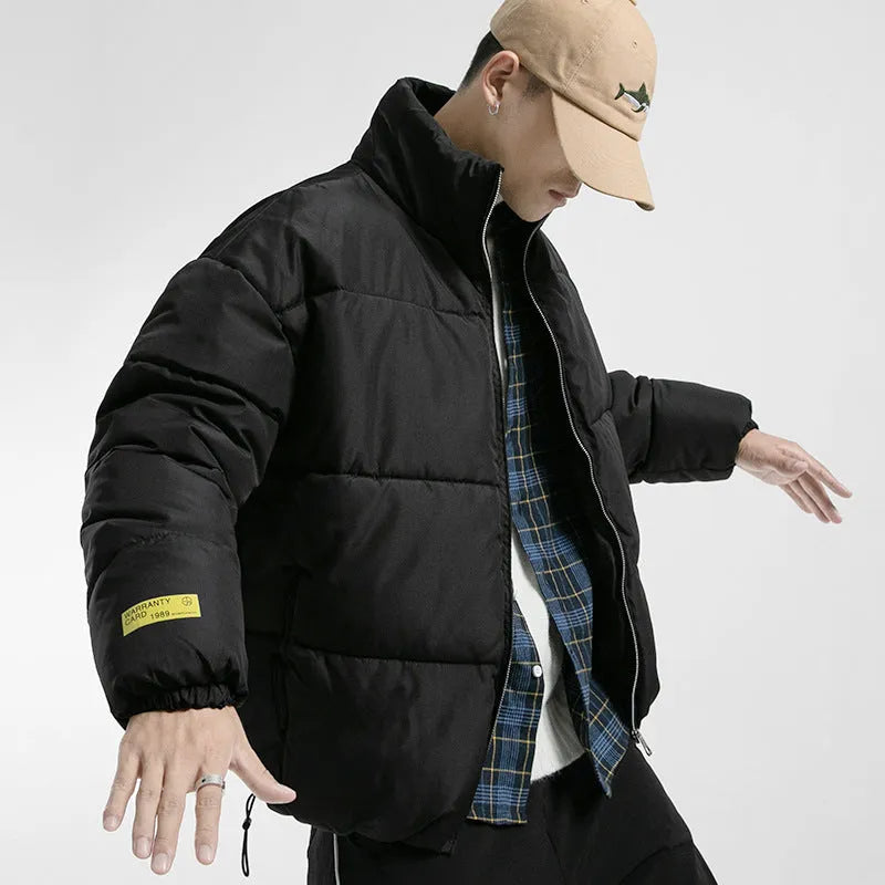Men's stand collar padded jacket with zip front, side slit pockets, and straight hem in black, green, or grey.