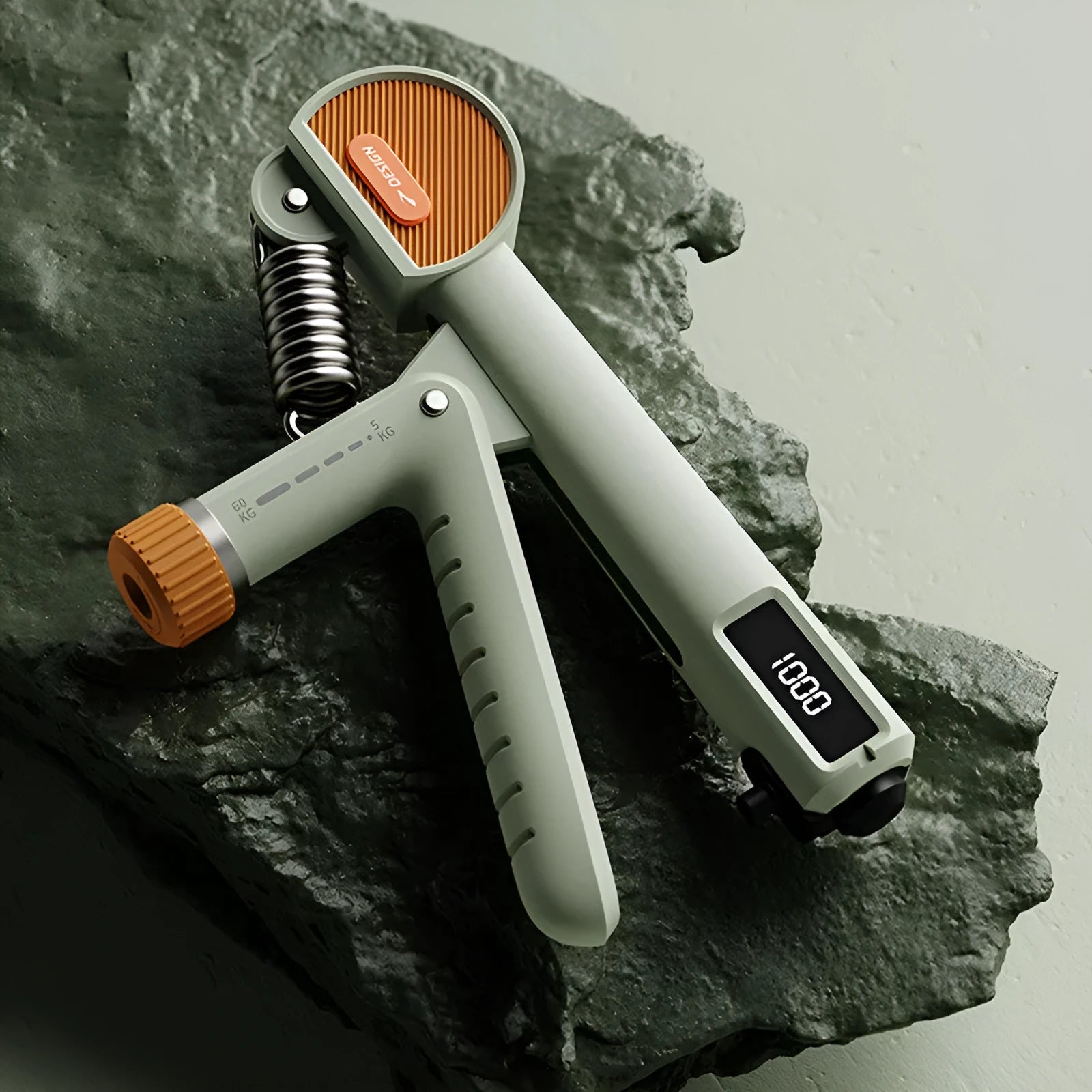Count Spring adjustable hand grip strength trainer in ABS plastic on a plain background.