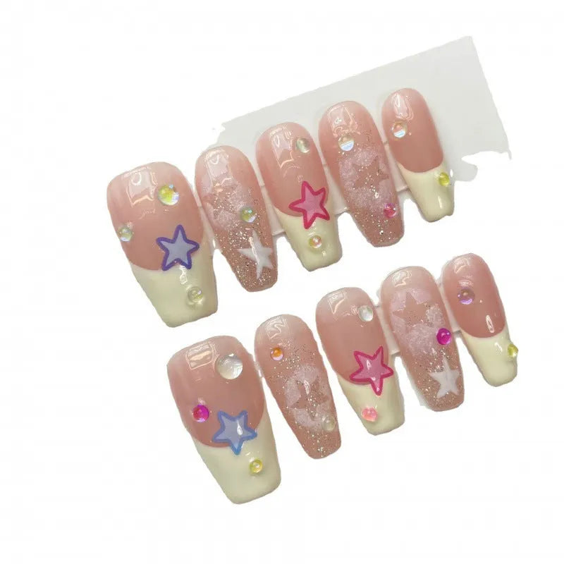 Handmade Sweet Star ladder pattern press-on nails in ultra-thin seamless style on a flat surface with glue and nail file