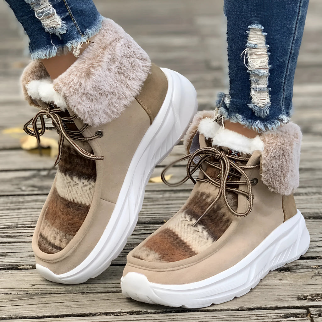Women's beige lace-up snow boots with fuzzy lining and a thick platform sole on a white background.