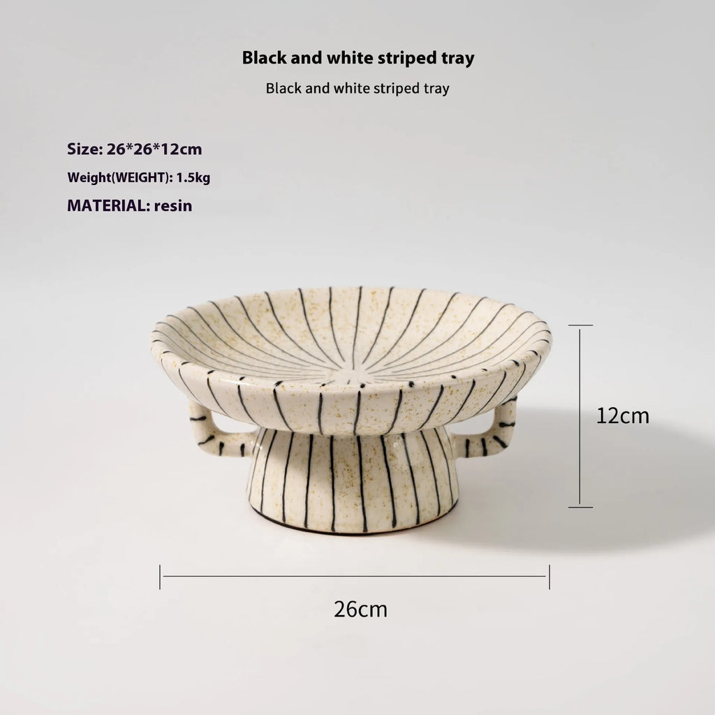 Black and white striped plastic resin fruit plate ornament, 16cm diameter, on a table.