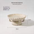 Black and white striped plastic resin fruit plate ornament, 16cm diameter, on a table.