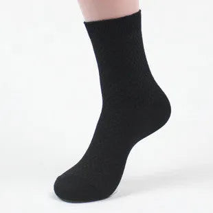 Men's bamboo fibre ankle socks in black with a small square pattern, laid flat.