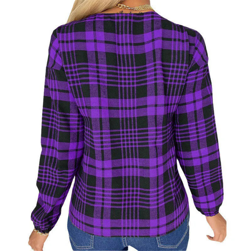 A woman wearing a loose-fitting purple plaid shirt with regular sleeves.