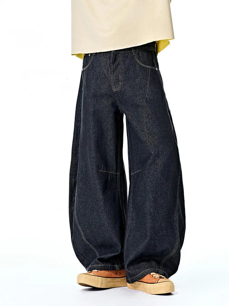 Men's original cow colour wide leg denim trousers laid flat, showing mid waist and straight leg cut.