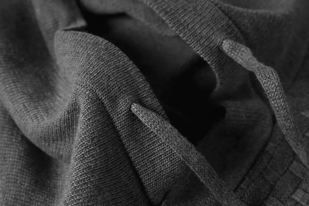 Men's grey cotton-polyester blend hooded sweatshirt on a hanger, showing front design and hood.