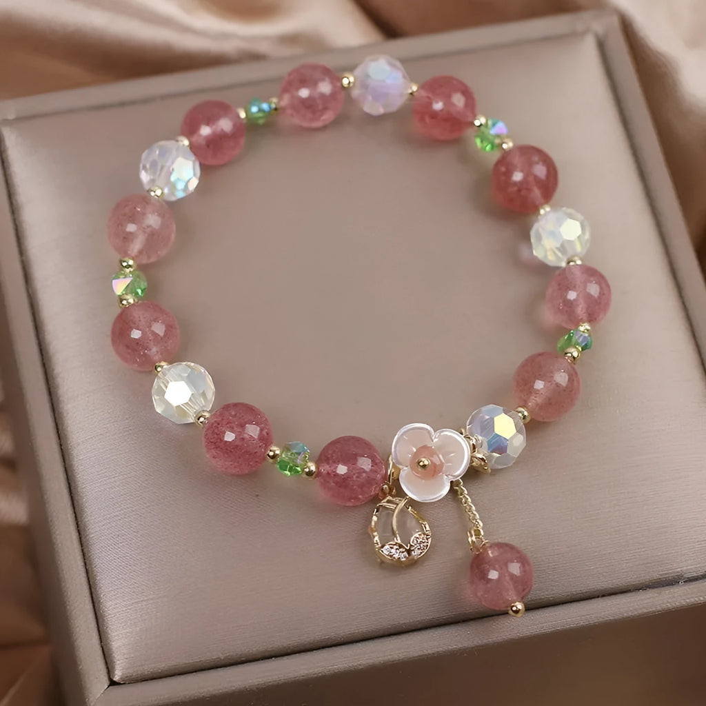 Women's double layer Strawberry Quartz crystal bracelet with Lucky Cat charm and red cat's eye flowers.