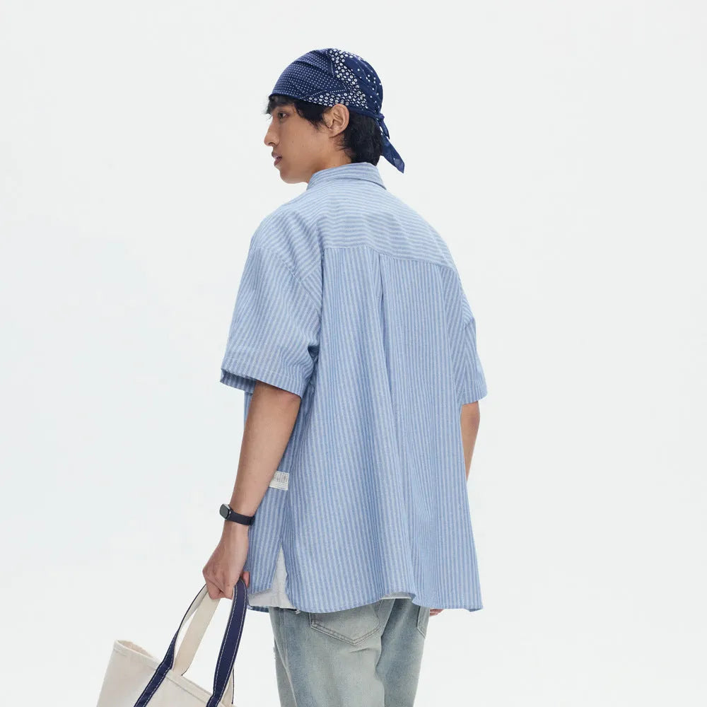 Blue striped short-sleeved overalls shirt in a loose cardigan style for casual wear.