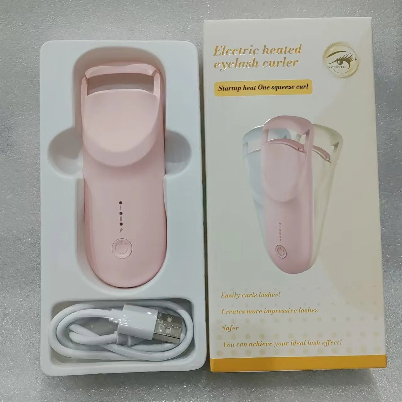 Electric heating eyelash curler in cream white colour with USB charging cable