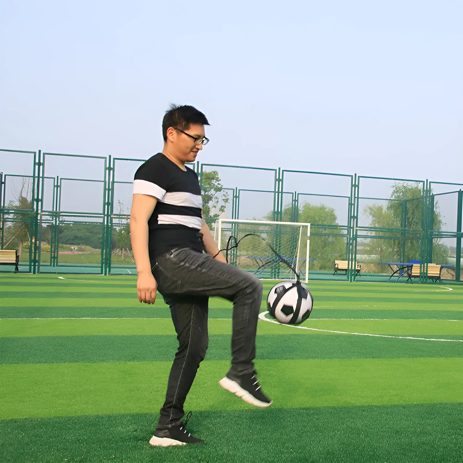 Black football juggling belt training equipment with rotating design for solo practice