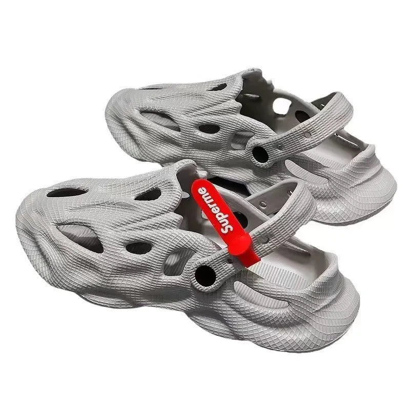 Pair of solid grey closed-toe EVA coconut slippers on a white background.