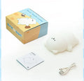 Lying flat bear silicone small night lamp with three-gear dimming and RGB colour switching on a bedside table