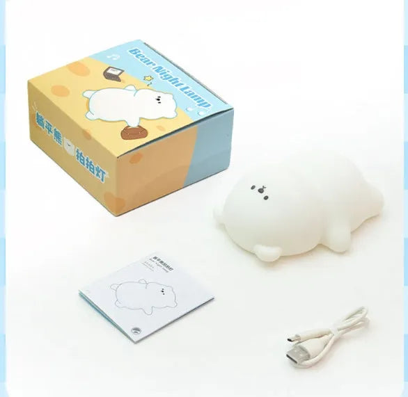 Lying flat bear silicone small night lamp with three-gear dimming and RGB colour switching on a bedside table