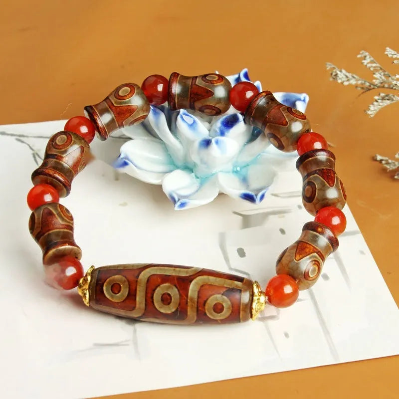 Distressed agate Tibet beads bracelet with three eye dzi design and polished stone beads