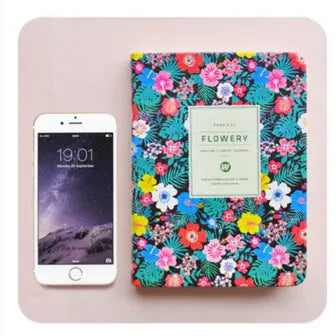 Green floral notepad with fabric imitation leather cover, shown open on a desk.