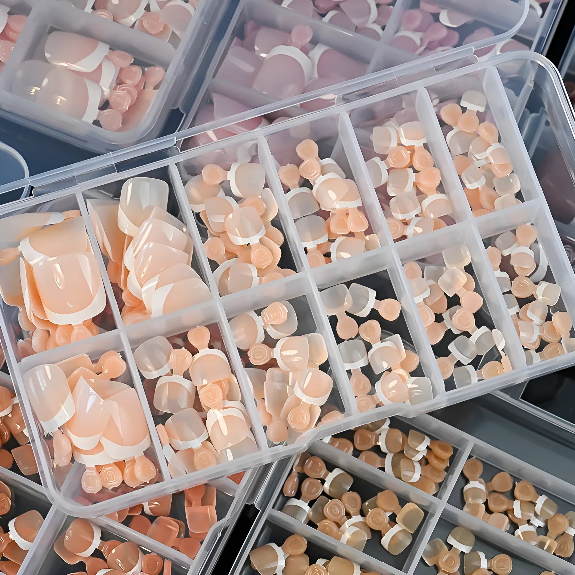 Box of 120 French white edge press-on toenails in nude colours on a full square short shape.
