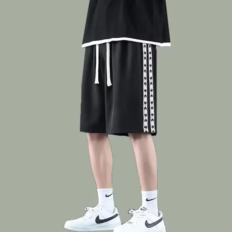 Men's black baggy track trousers with elastic waistband and loose sport fit