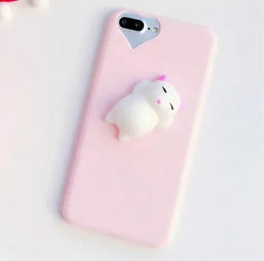 Soft pink silicone iPhone case with a raised 3D cartoon cat design on the back.