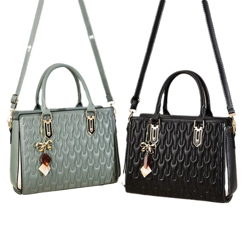 Women's polyester shoulder messenger bag with a front PU pocket in green, showing its structured shape and strap.