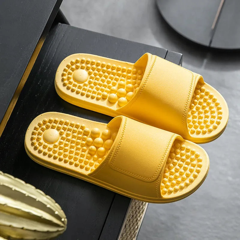 Pair of non-slip PVC massage slippers with breathable upper and wear-resistant injection-moulded sole, available in seven colours.