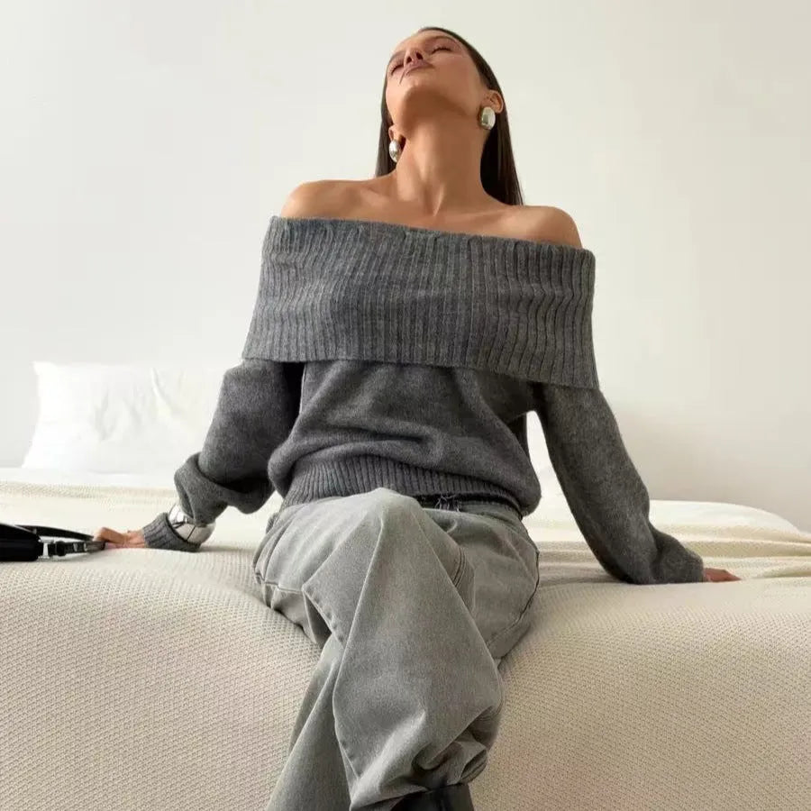 Woman wearing a grey off-the-shoulder sweater with a 3D textured pattern.