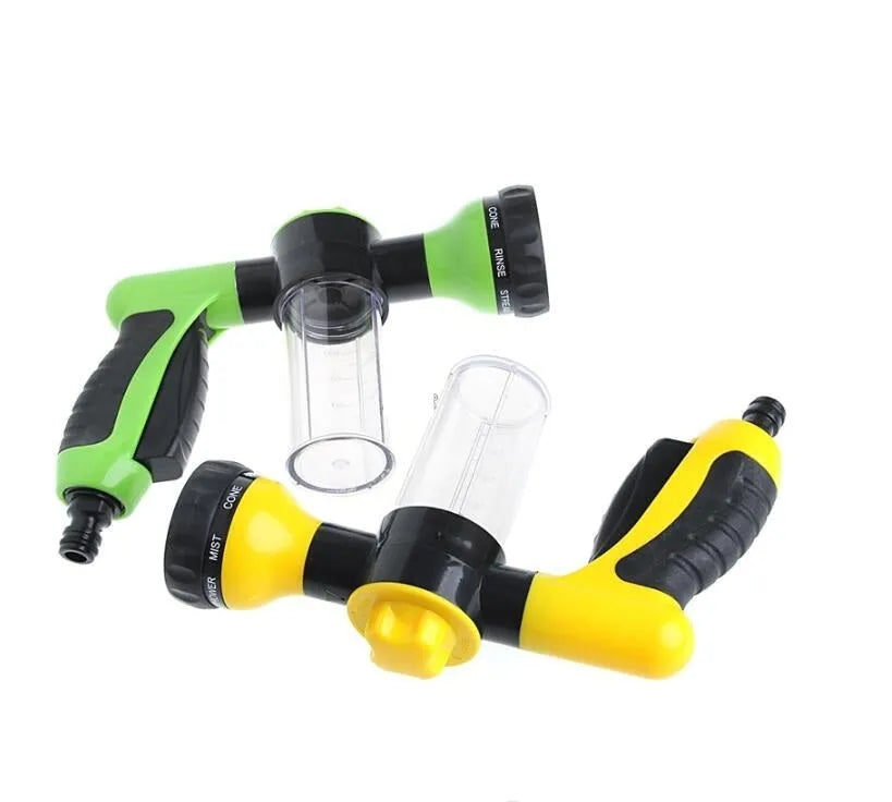 Green high-pressure foam spray gun with adjustable nozzle and attached water pipe for car and garden cleaning.