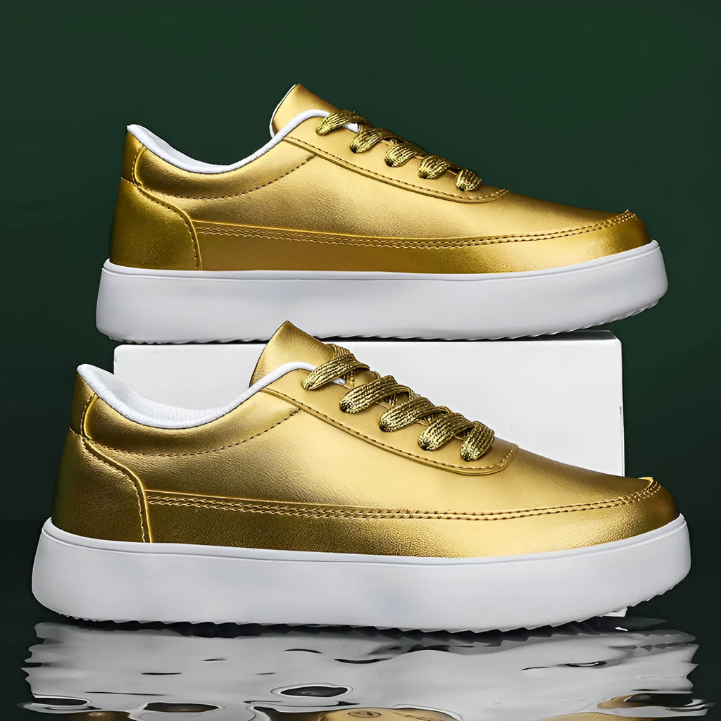 Women's gold leather flat casual lace-up shoes on a white background.