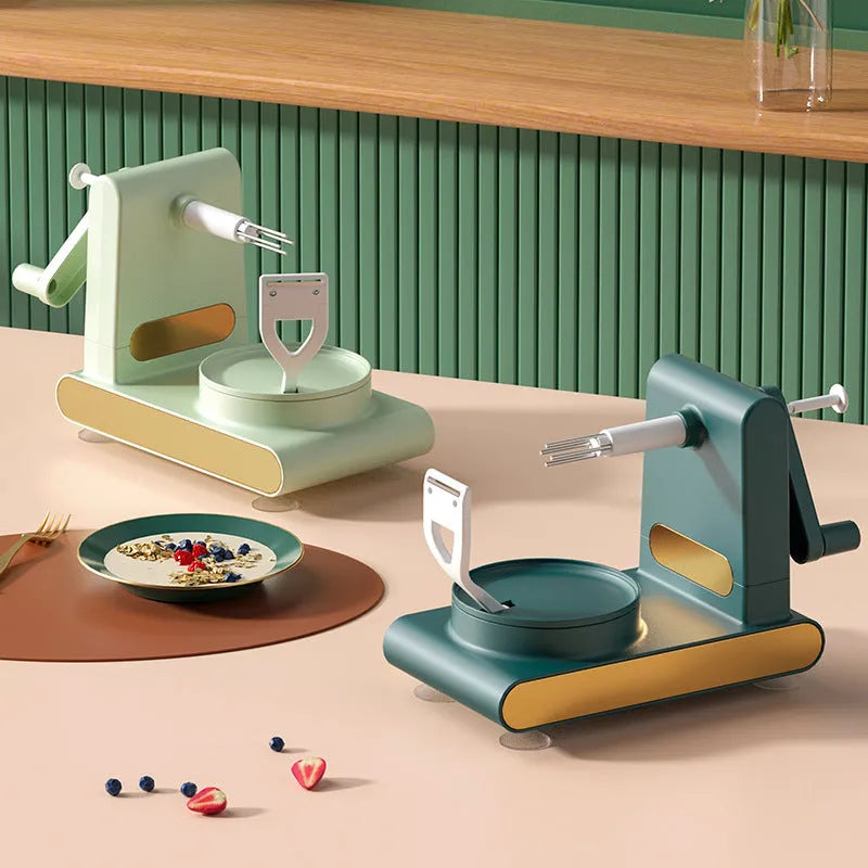 Hand-cranked peeler machine with suction base and fruit return button in light green, ABS plastic and metal