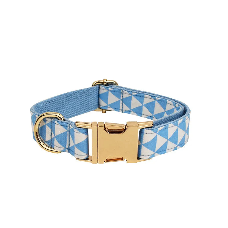 Blue triangular ring pattern dog accessory set with collar, leash, bow, and vest