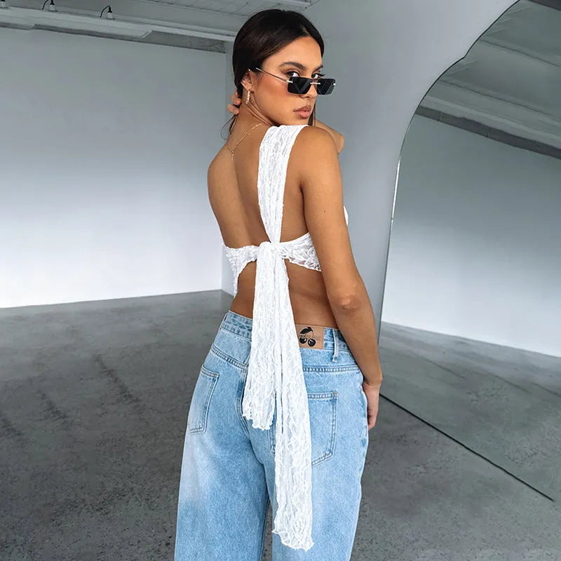 Women's apricot lace backless sleeveless vest top with asymmetrical neckline on a hanger.
