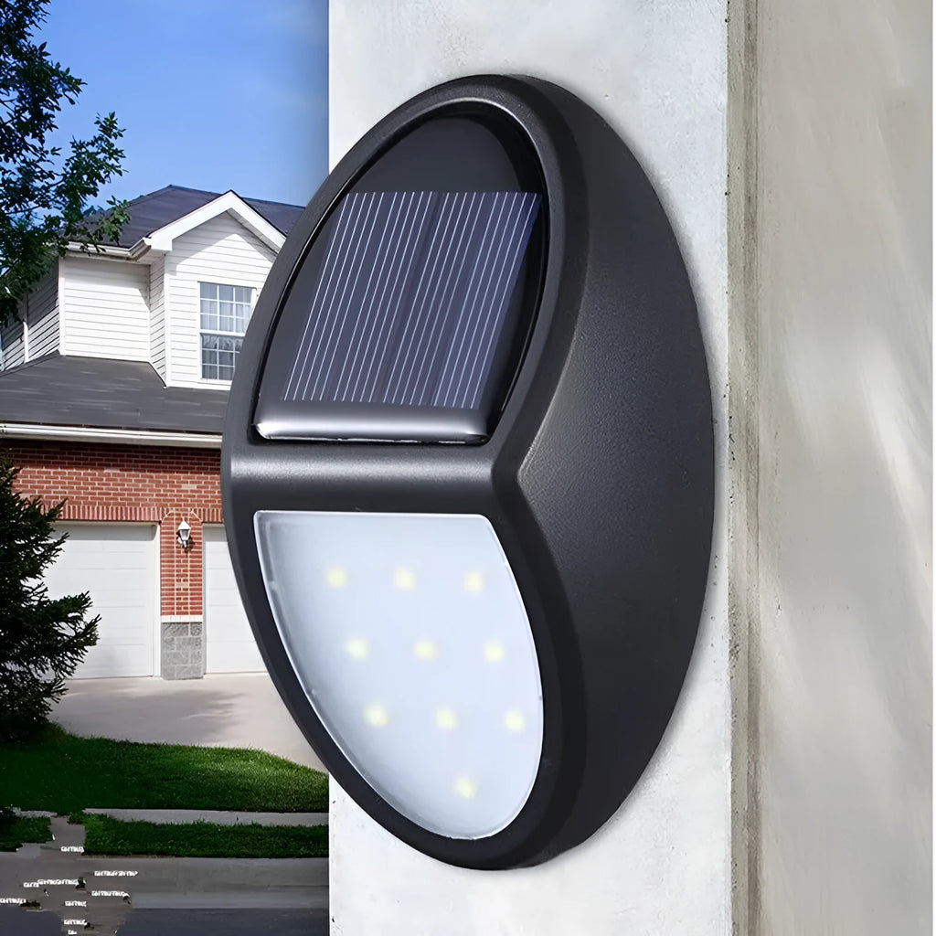 Black rectangular LED solar wall light mounted on an outdoor surface
