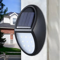 Black rectangular LED solar wall light mounted on an outdoor surface
