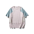 Men's loose blue patchwork t-shirt with raglan short sleeves on a white background.